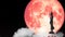 Super full red moon and Buddha looking seven day style on the night sky and white cloud time lapse