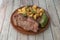 Super grilled beef entrecote with fried green pepper and garnish of diced fried potatoes