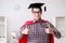 The super hero student wearing mortarboard in a red cloak