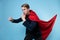 Super man fights with enemies. Businessman in a suit with a red cape,