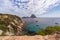 Super panoramic view Es Vedra rock on horizon and piercing blue summer sky full of ragged small white clouds, Ibiza