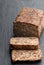 Super seed vegan loaf free from wheat and yeast on black stone background