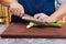 Super sharp Japanese kitchen knife cut zucchini into ultra thin slice on wooden chopping board