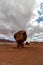 Super sized boulder stands under the cloudy sky, Vermillion cliff range, Page, AZ, USA