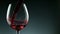 Super Slow Motion Detail Shot of Pouring Red Wine from Bottle on dark Background.