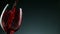 Super Slow Motion Detail Shot of Pouring Red Wine from Bottle on dark Background.