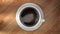 Super slow motion drops of coffee are falling into cup
