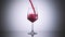 Super slow motion high speed shot of red wine flowing into a big bordeaux wineglass
