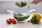 Super Slow Motion Shot of Flying Cuts of Colorful Vegetables and Water Drops Close up of hands people washing vegetables