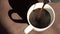 Super slow motion top view of coffee pour into cup from geyser coffee maker