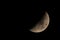 super telephoto image of the moon at night sky during the waxing crescent phase