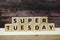 Super Tuesday alphabet letter on wooden background