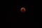 Super wolf blood moon lunar eclipse, nearly fully eclipsed and blood red