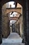 Superb street, between historic buildings, next to the cathedral of San Zeno in Pistoia. Pistoia is a city in Tuscany. Around its