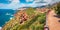 Superb summer cityscape of Nebida town with Porto Corallo on background. Panoramic morning view of Sardinia island, Italy, Europe.