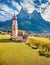 Superb view from flying drone of St. Valentin  Kastelruth  church with Petz peak on background.