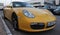 Supercar Porsche 911 finished in yellow in the street. Sankt Petersburg Russia, 08 2022