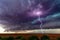 Supercell thunderstorm with dark clouds and lightning.