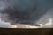 A supercell thunderstorm develops a wall cloud and begins to rotate over the plains of eastern Colorado.