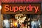 Superdry text sign and logo front of british shop brand fashion clothing company