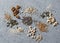 Superfood ingredients. Assortiment seeds and nuts on a gray background, top view. Flax seeds, sesame seeds, walnuts, sunflower see