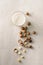 Superfood. Organic macadamia nuts and glass of macadamia milk on stone background