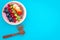 Superfoods. Acai smoothie bowl with fresh fruits, berries, chia seeds on blue background top view space for text