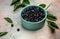 Superfoods antioxidant of indian mapuche. Bowl of fresh maqui berry on light background, top view