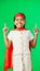 Superhero, point and face of child on green screen for fantasy, cosplay costume and comic character. Advertising, copy