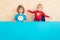 Superheroes children holding blue banner blank