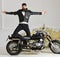 Superiority concept. Hipster biker brutal in leather jacket on motorcycle enjoying richness. Man, bearded biker in