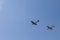 A Supermarine Spitfire and North American P-51 Mustang flying in tandem