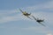 A Supermarine Spitfire and North American P-51 Mustang flying in tandem