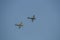 A Supermarine Spitfire and North American P-51 Mustang flying in tandem