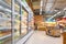 Supermarket aisle with commercial refrigerators freezer showing frozen foods blur background