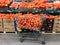 Supermarket cart and shelf full of oranges