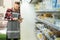 Supermarket clerk using a touch screen tablet, innovative technology and work, order groceries for the grocery store