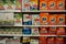 Supermarket display with different brands of washing powder in boxes. Wholesale. Tide, Ariel, Omo laundry detergent boxes lined up