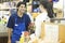 Supermarket Employee Assisting Female Customer