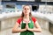 Supermarket employee meditating with palms together