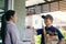 Supermarket food delivery staff deliver bags to female customers in front of the house