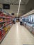 Supermarket interior with shelves full of various products, people at shopping. Bucharest, Romania, 2021