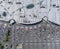 Supermarket roof and many cars in parking, viewed from above.