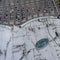 Supermarket roof and many cars in parking, viewed from above.