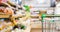 Supermarket shopping cart with abstract blur organic fresh fruits and vegetable