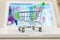 supermarket shopping cart on laptop background close-up, macro, online shopping concept and purchasing power, consumer shopping