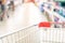 Supermarket store blurred background with close up shopping cart