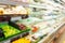 Supermarket store with fruit and vegetable on shelves blurred background