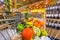 Supermarket trolley with fruit and vegetables on alcohol section