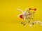 supermarket trolley on yellow background, shells inside, release, Concept of shopping. Copy space for advertisement.